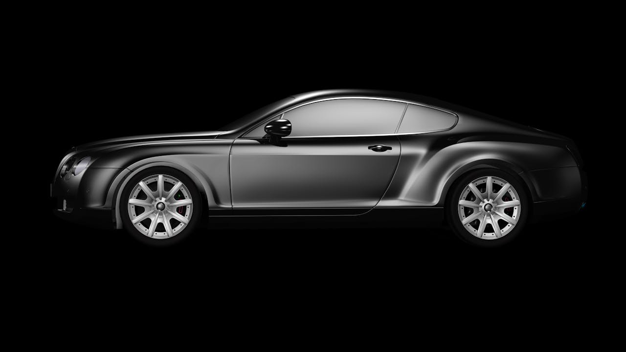 Crafting Captivating Headlines: Your awesome post title goes here A side profile of a luxurious black coupe on a plain black background, showcasing elegance.