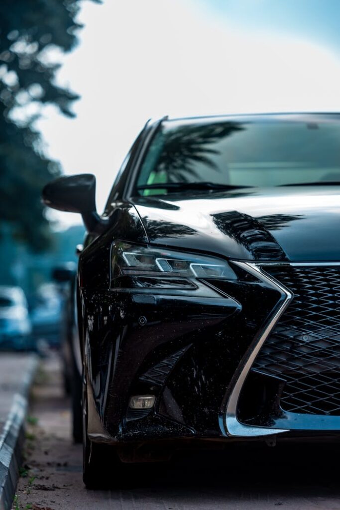 pexels photo 29571170 Front view of a sleek black luxury car parked on an outdoor street in Abuja, Nigeria.